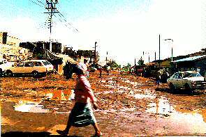 Eine Strae in den Slums nach dem Regen. A Street in the slums after the rain.
