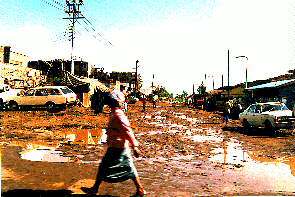 Eine Strae in den Slums nach dem Regen. A Street in the slums after the rain.